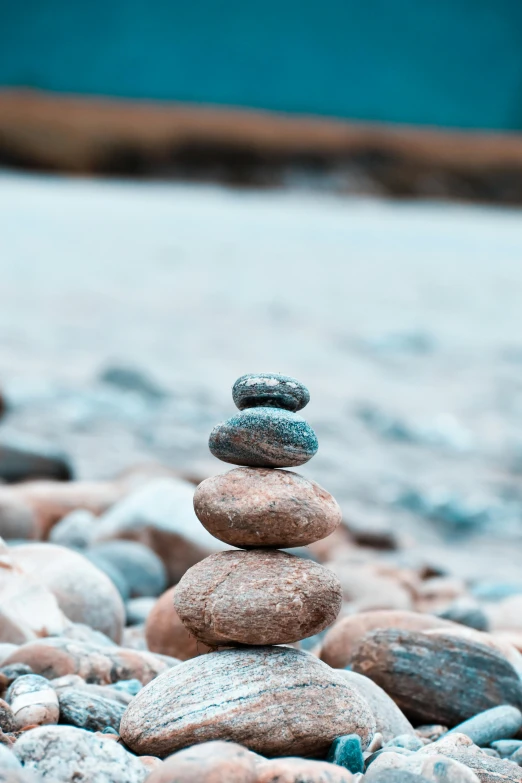 the balance rocks are balanced on top of each other on the beach