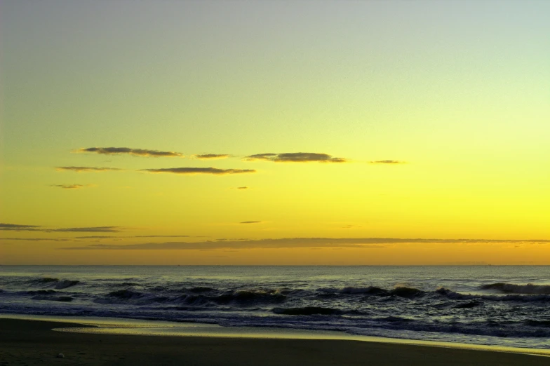 some people on the beach with surfboards and waves