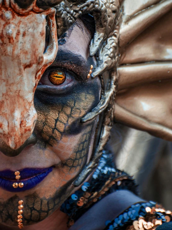 a woman wearing face makeup with a dragon head