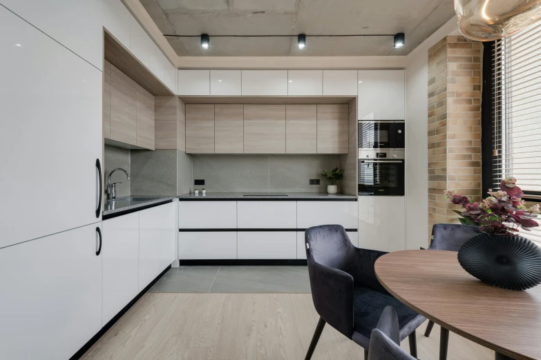 a view of a kitchen, dining table and the counter