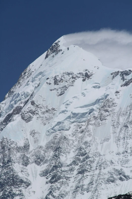 a large snow covered mountain with blue skies