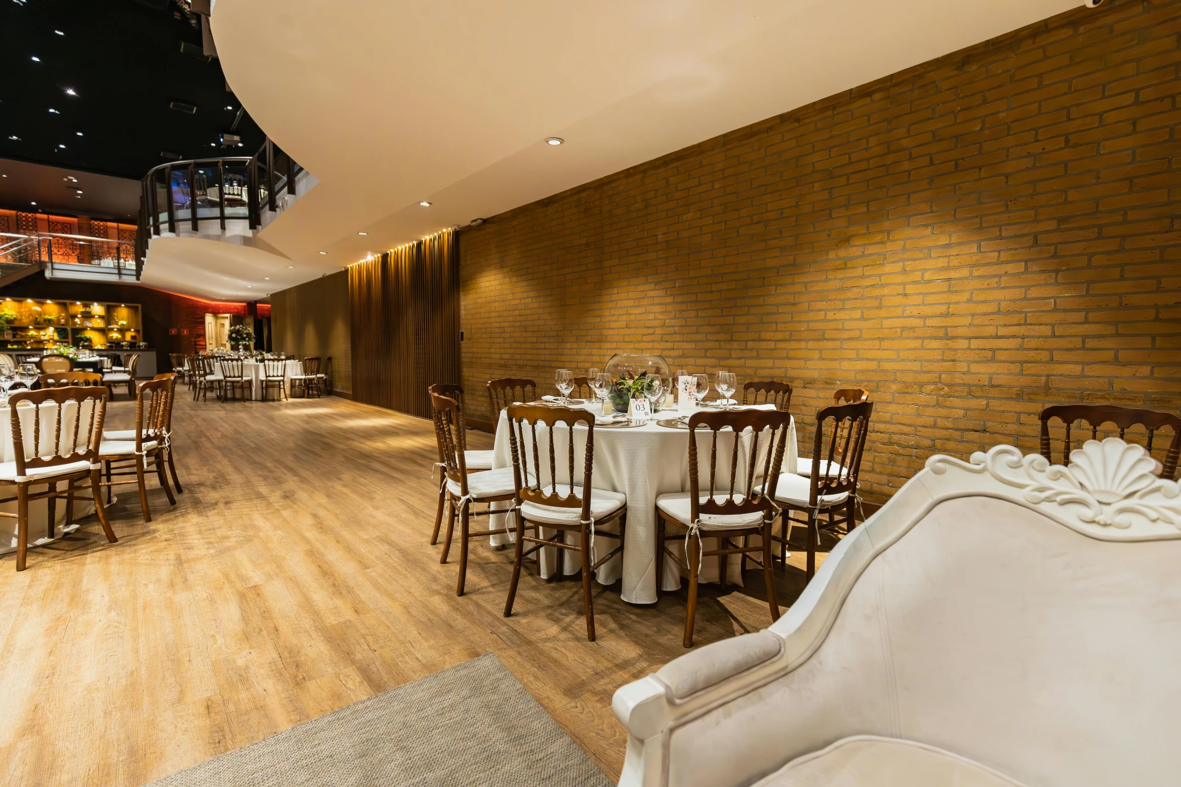 an elegant set banquet table setup with chairs and white linens