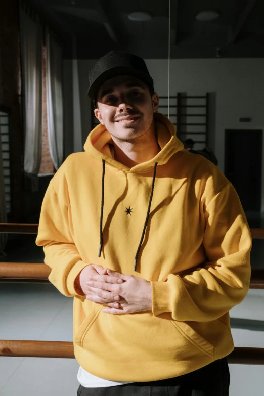 a man is wearing a hoodie and posing for a picture