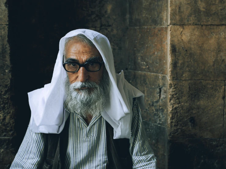 an old man with a long grey beard wearing sunglasses