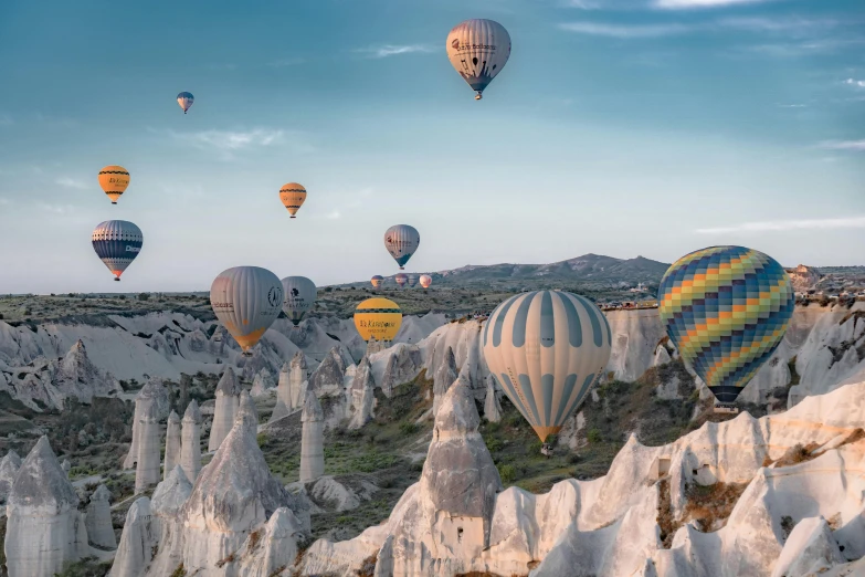 large group of  air balloons flying high up in the sky