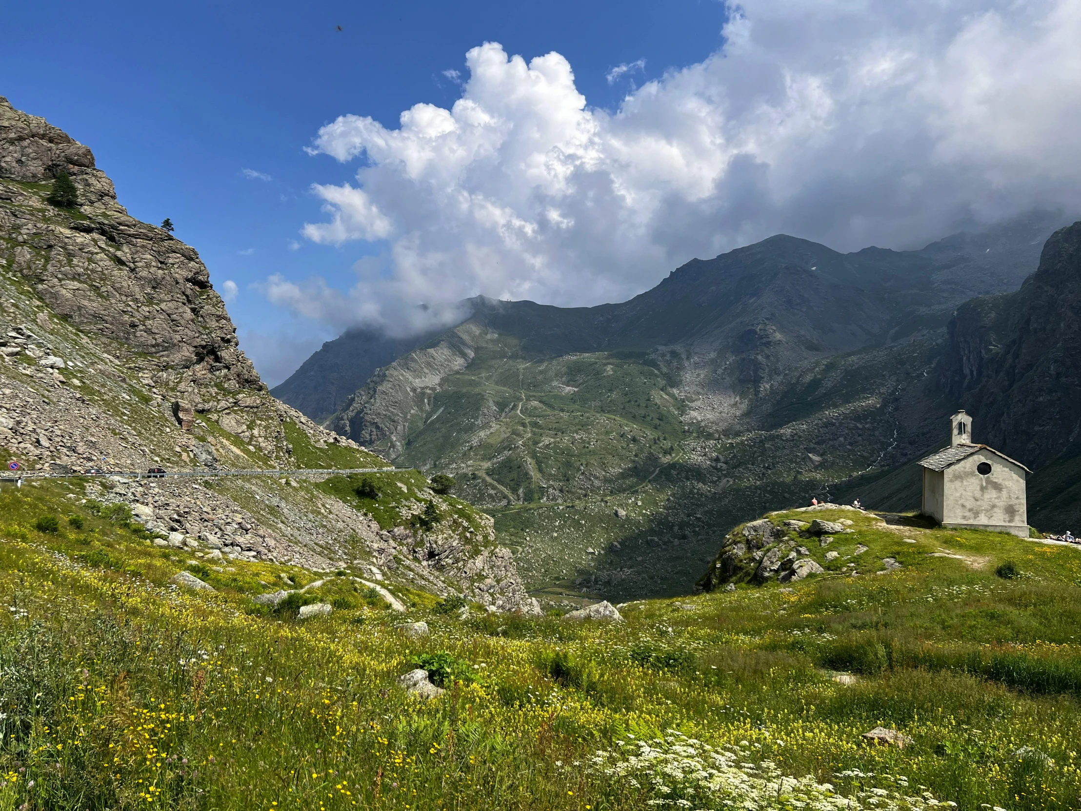 a grassy hill with a small chapel in the middle of it