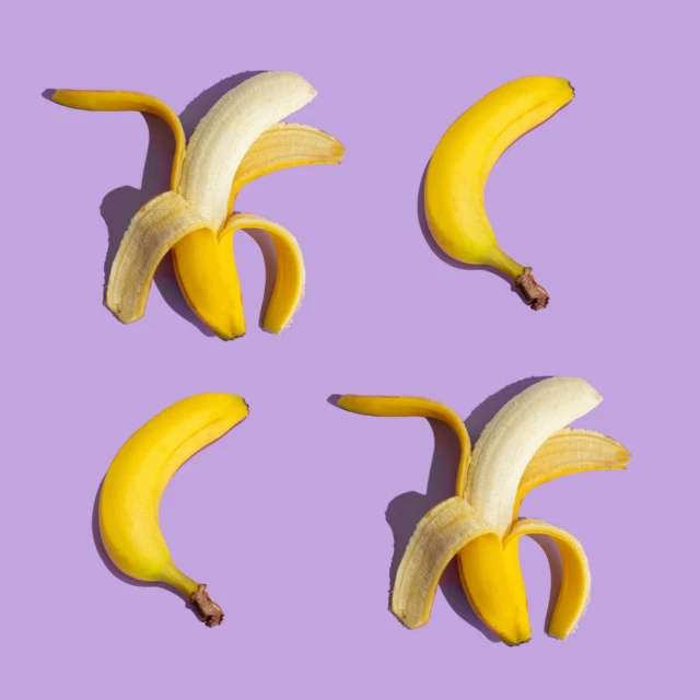 four bananas are arranged to form an eight in the shape of a face