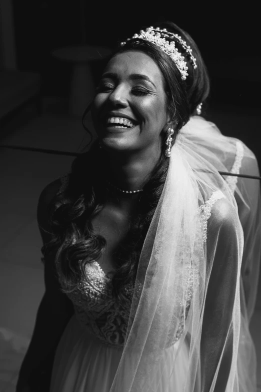 black and white pograph of smiling bride wearing veil