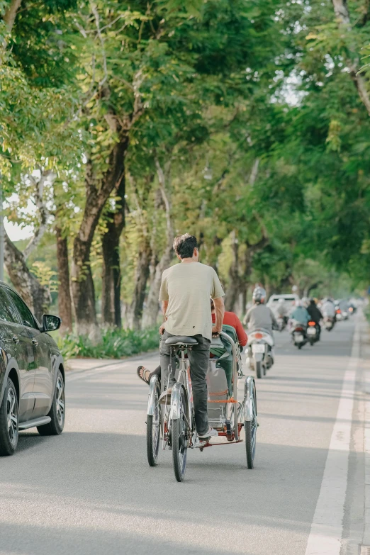 a person rides a small motorcycle next to a car