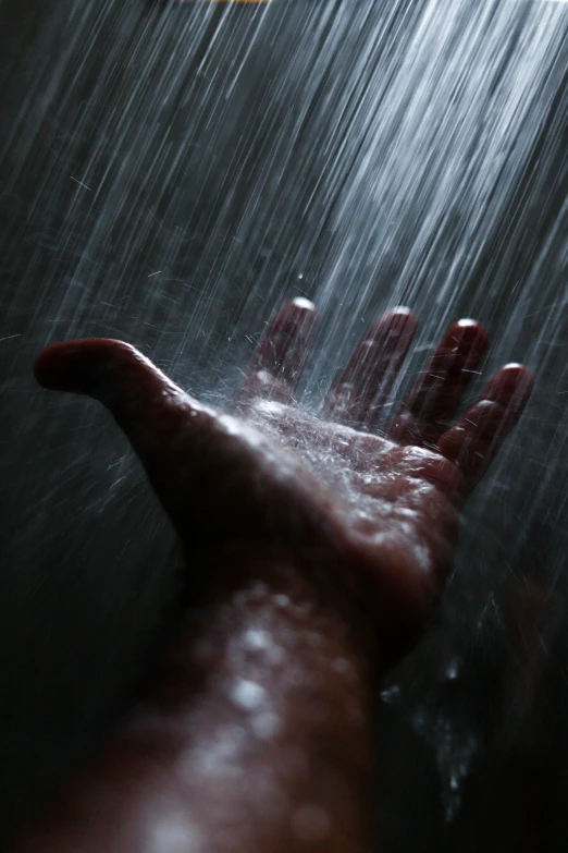 someone's hand reaching for a shower