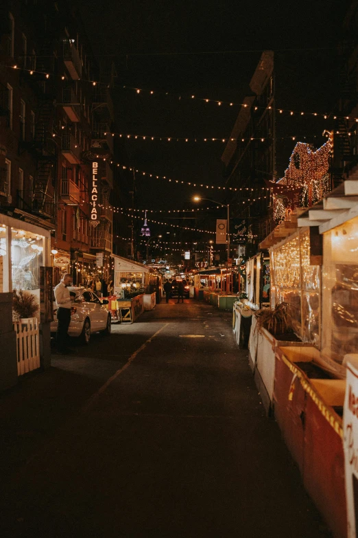 a town street filled with christmas lights at night