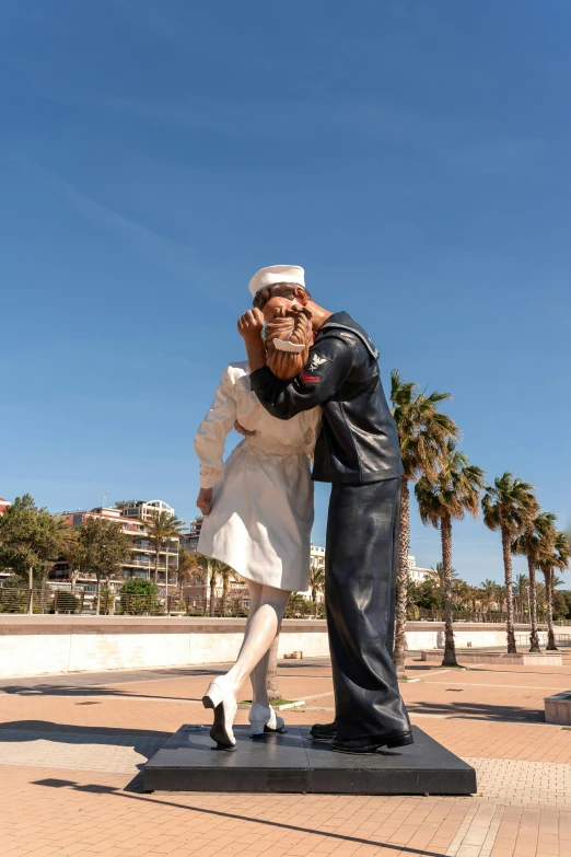 a statue of a sailor hugging a woman's head