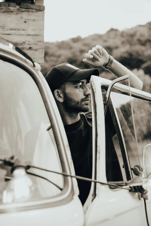 a man standing in the passenger window of a truck