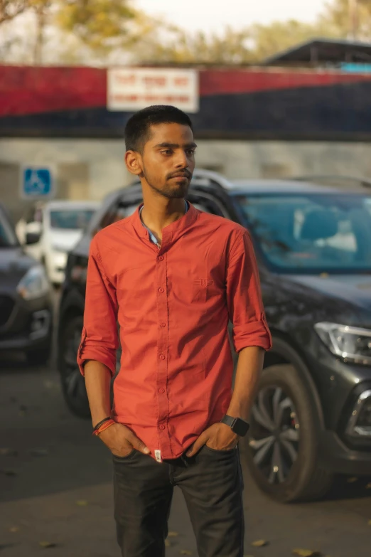 a man is standing on the street in front of cars