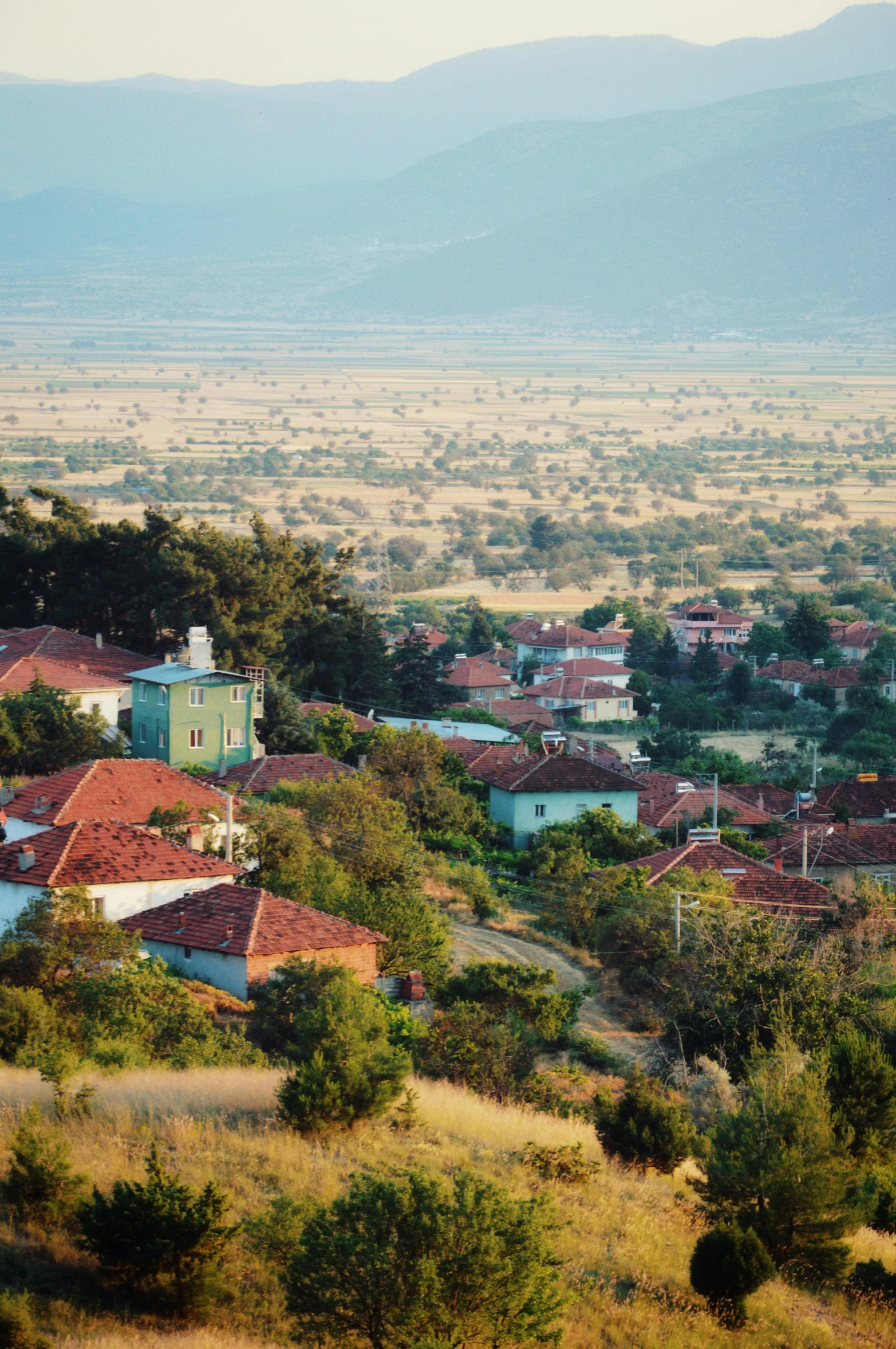 a small town is nestled in an area near mountains