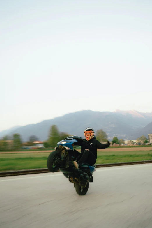 the motorcyclist is driving down the road on his motorcycle