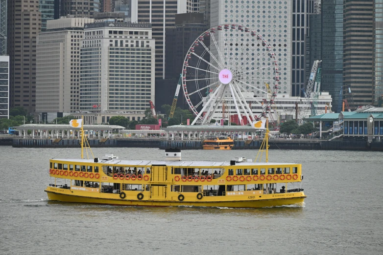 a ferry boat floating in the water near some buildings