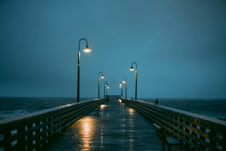a pier is lit up in the dark