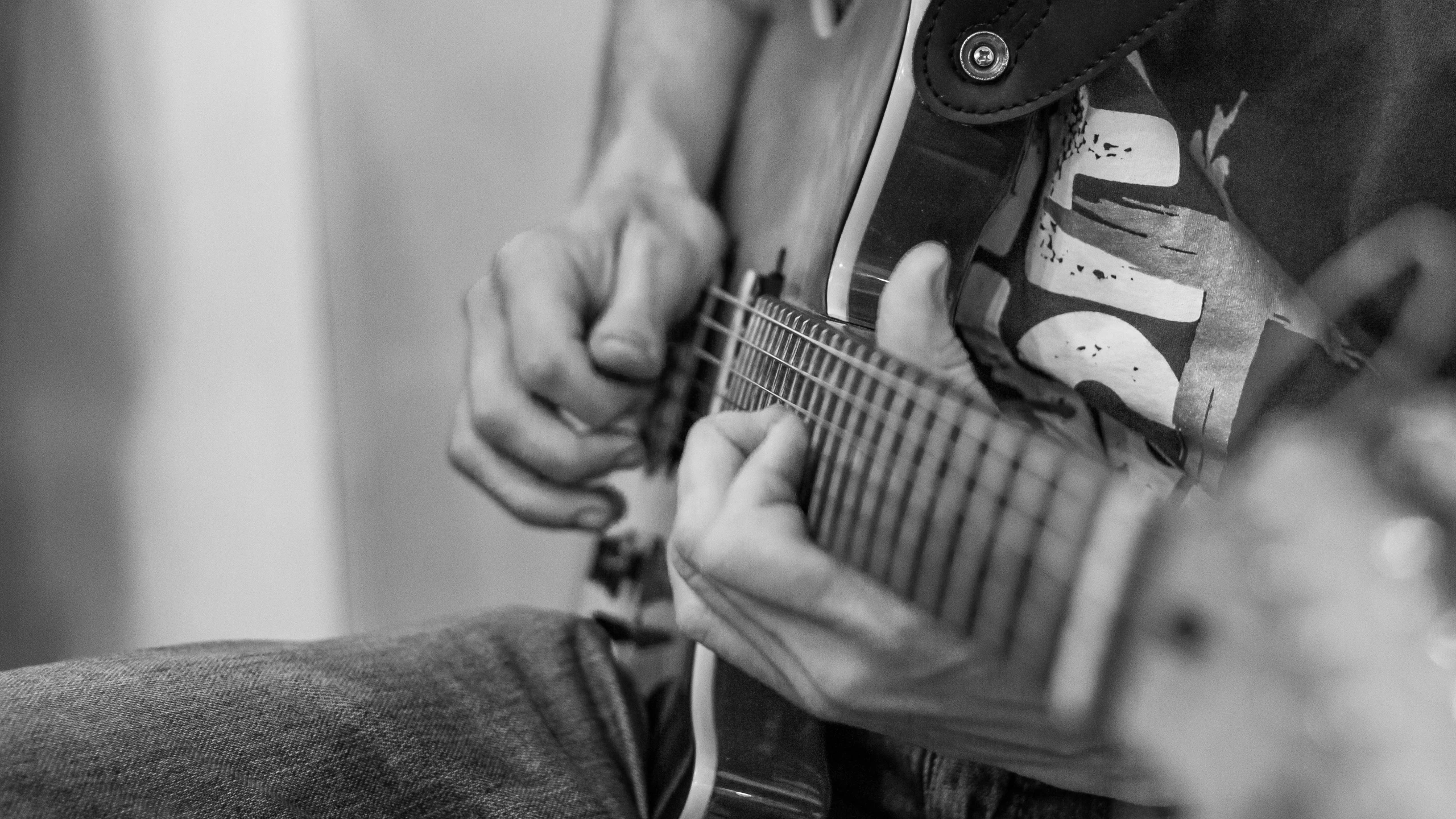 a man holding an acoustic guitar with both hands