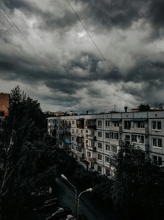 a street view of tall building with lots of wires above