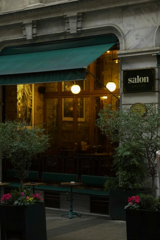 a restaurant with an awning and lots of chairs outside