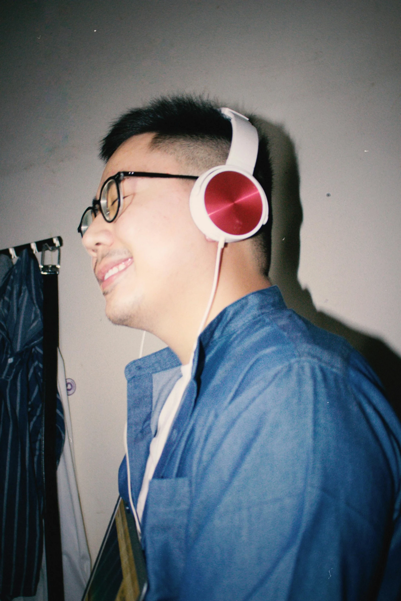 a man wearing headphones while looking up at the wall