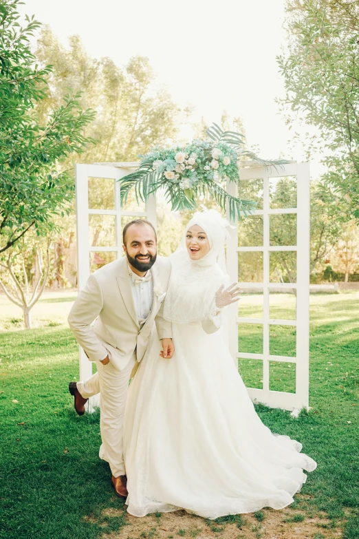 a man and woman in wedding dresses standing next to each other