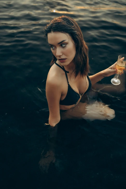 young beautiful woman in bikini holding a glass of wine