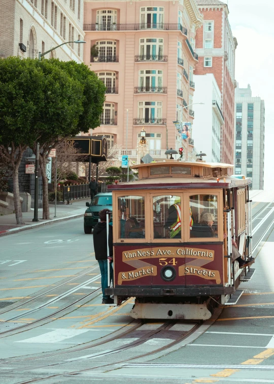 the trolley is headed down the road in a vintage city