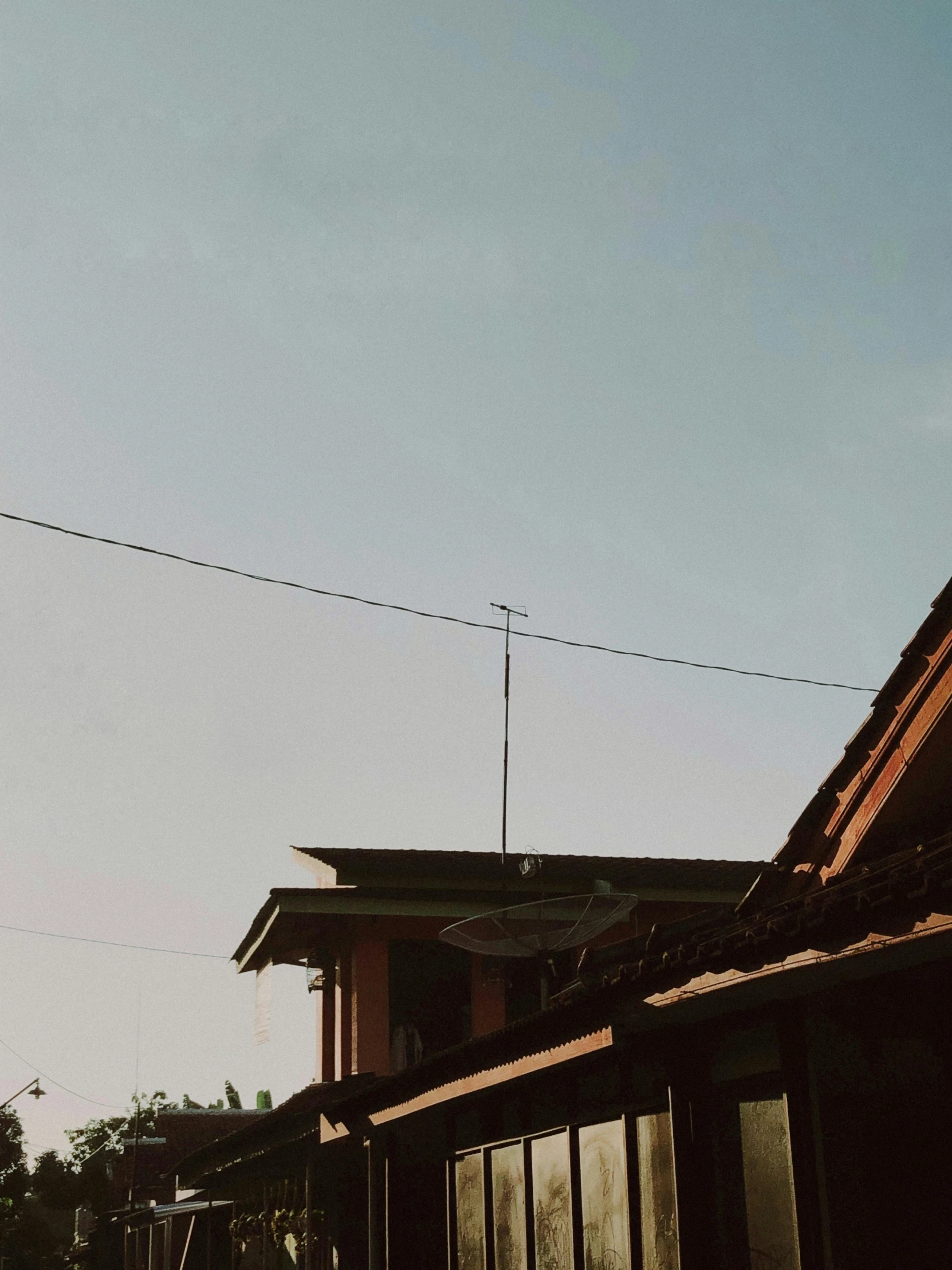 there are a clock and two buildings with a sky background