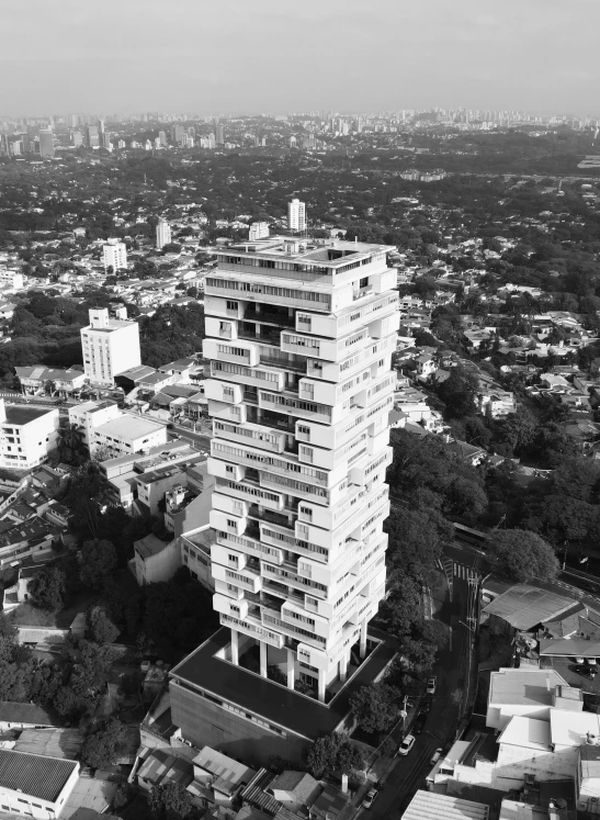 an aerial s of a very tall building on top of some buildings