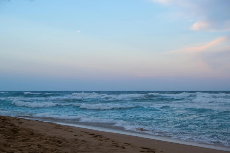 a person is standing on a beach with surfs