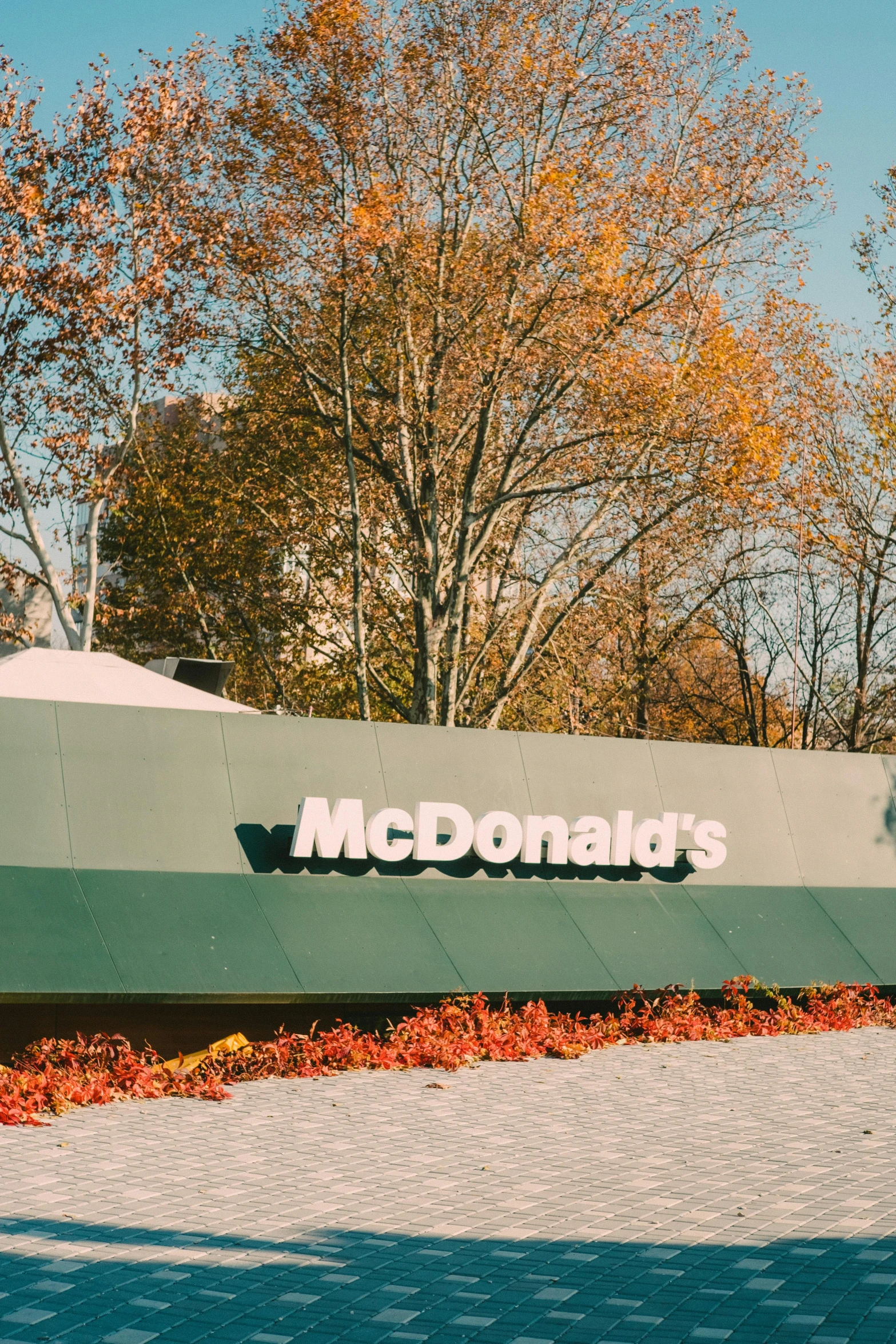 the sign outside a mcdonald's restaurant on a sunny day