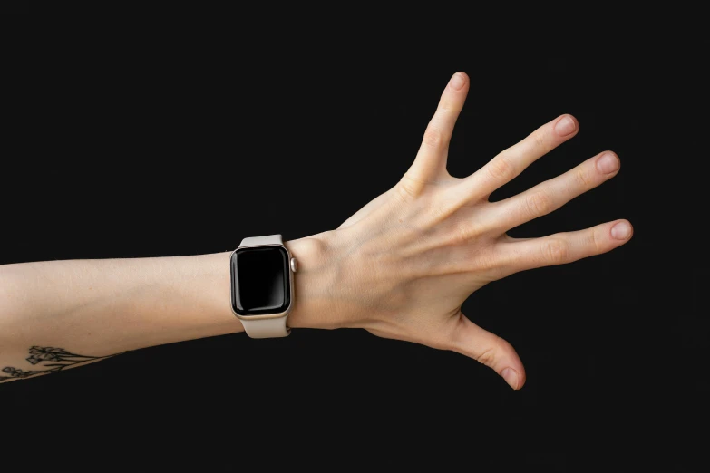 an apple watch on a wrist with tattooed hands