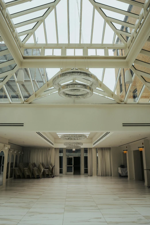 an indoor area with a long ceiling, chandelier and marble floor