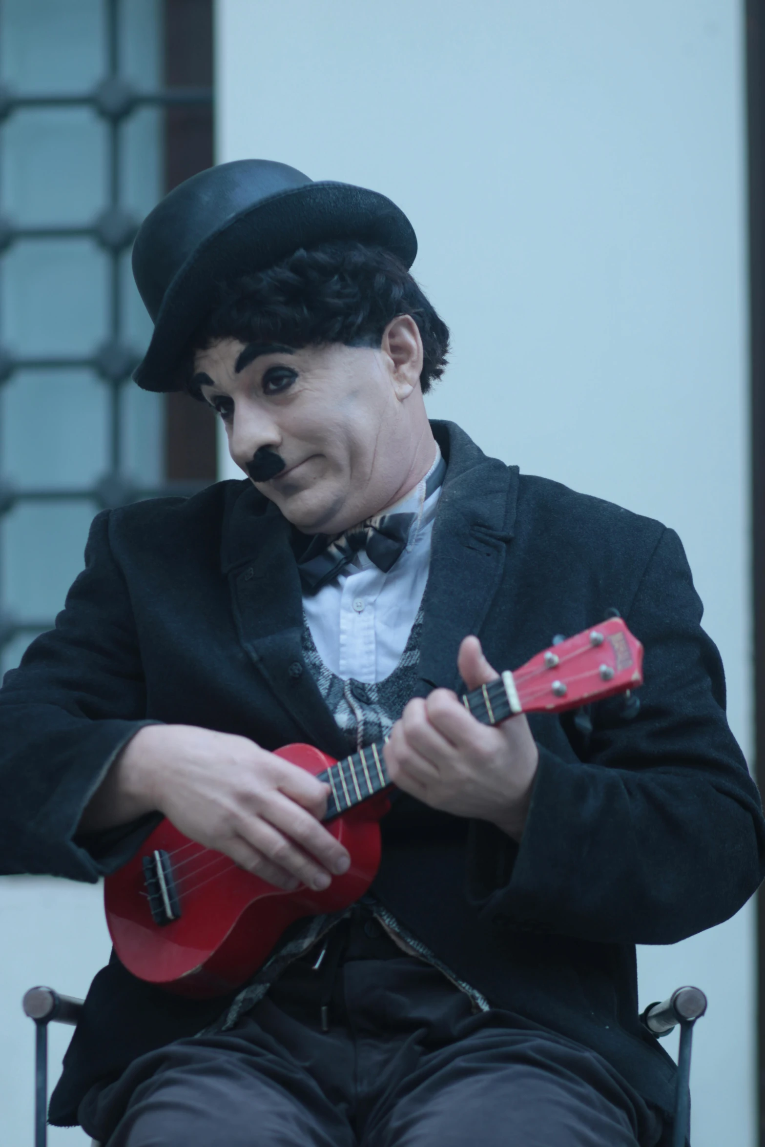 a man dressed in victorian garb playing an electric guitar