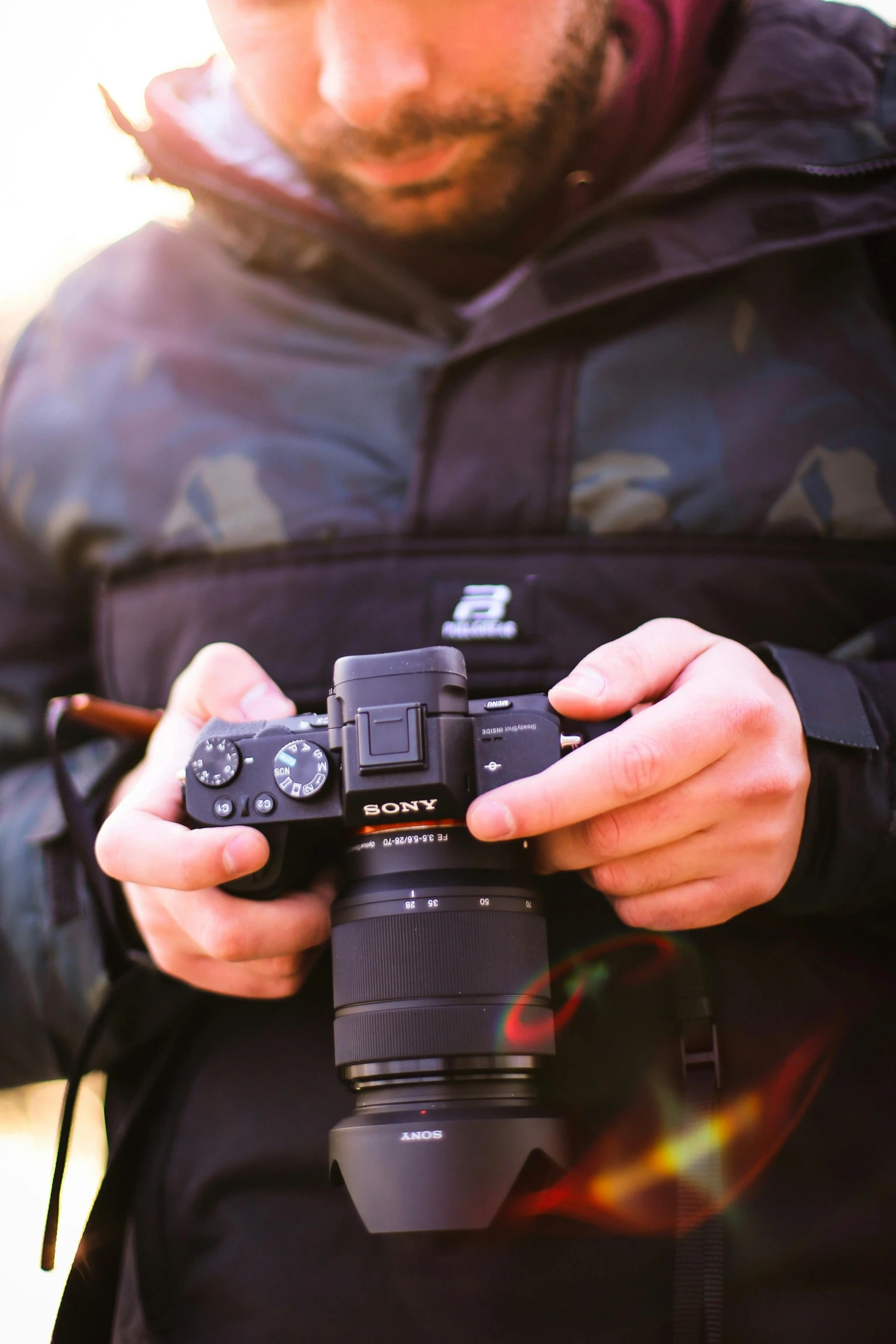 a man holding an electronic camera on his chest