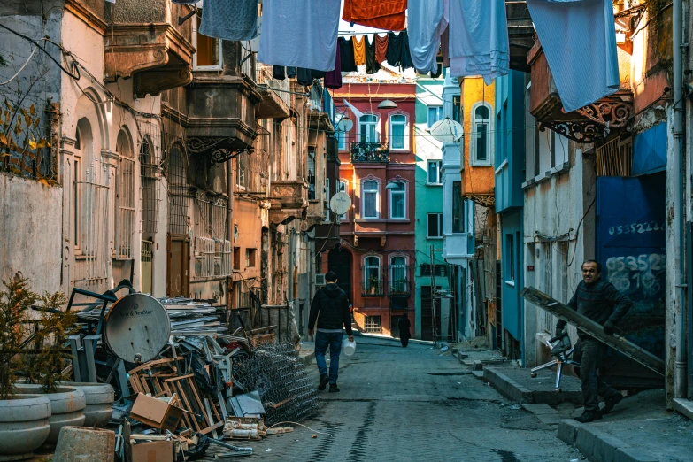 a man walking down a narrow road in a city