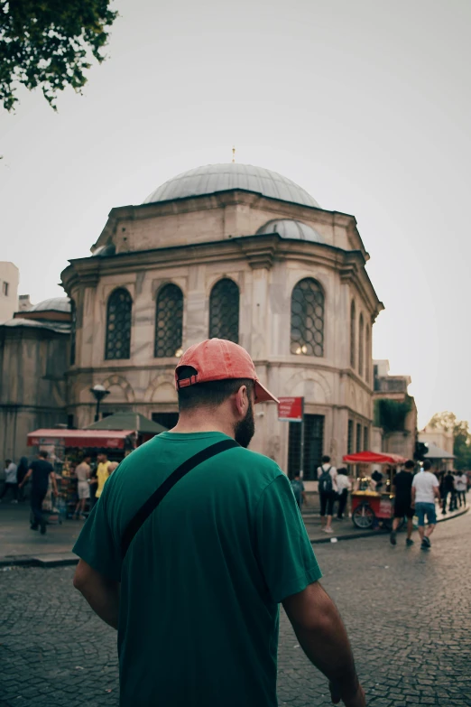 a man looking up at a circular building