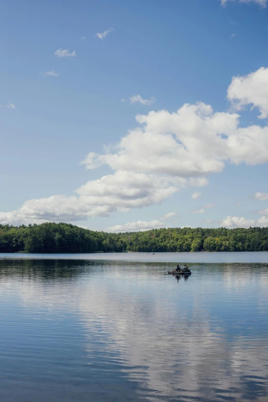 the clouds above a lake are reflected by the calm waters