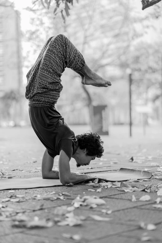 a person doing a handstand in the park