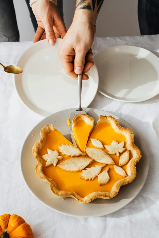 a person is serving slices of pie on a plate