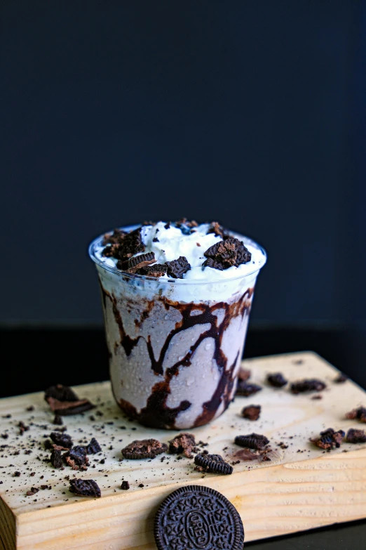 chocolate dessert sitting next to an oreo cookie