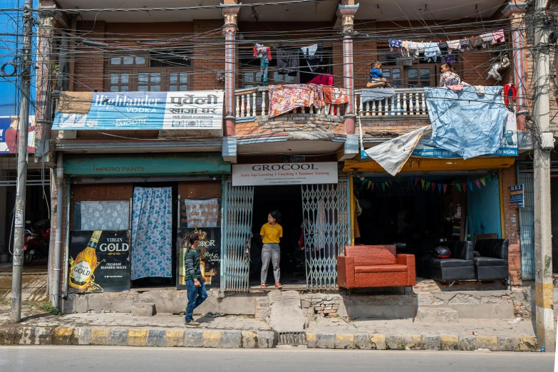 a man is standing on the street outside a building