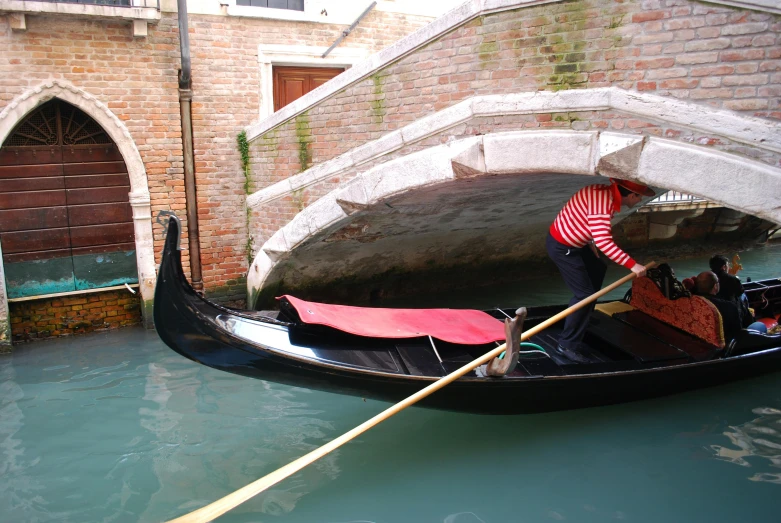 a boat floating down the water with people in it