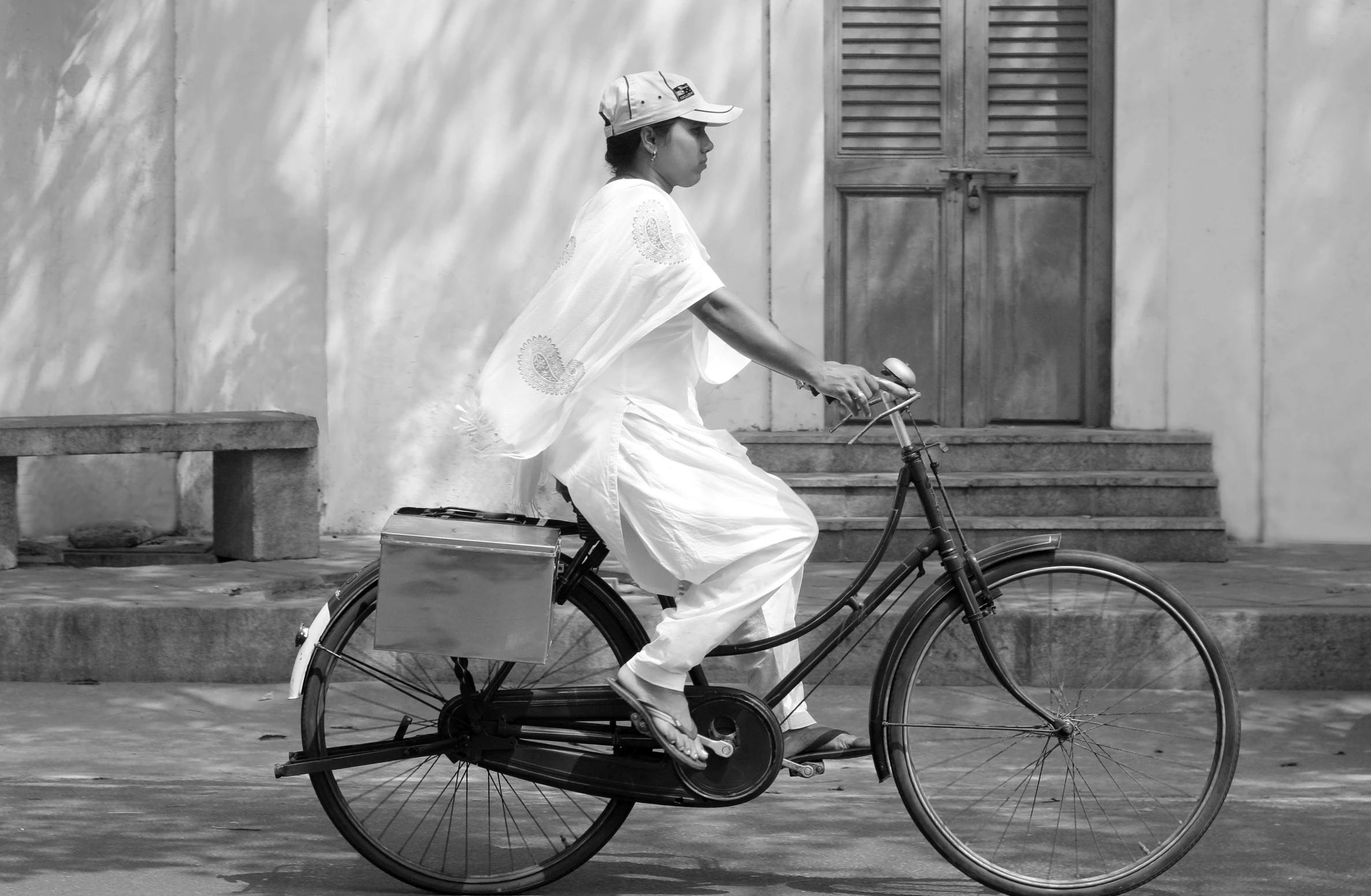 a black and white po of a woman riding a bike