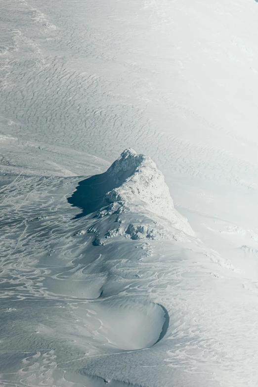 a small snow covered mountain with snow plowed off the side