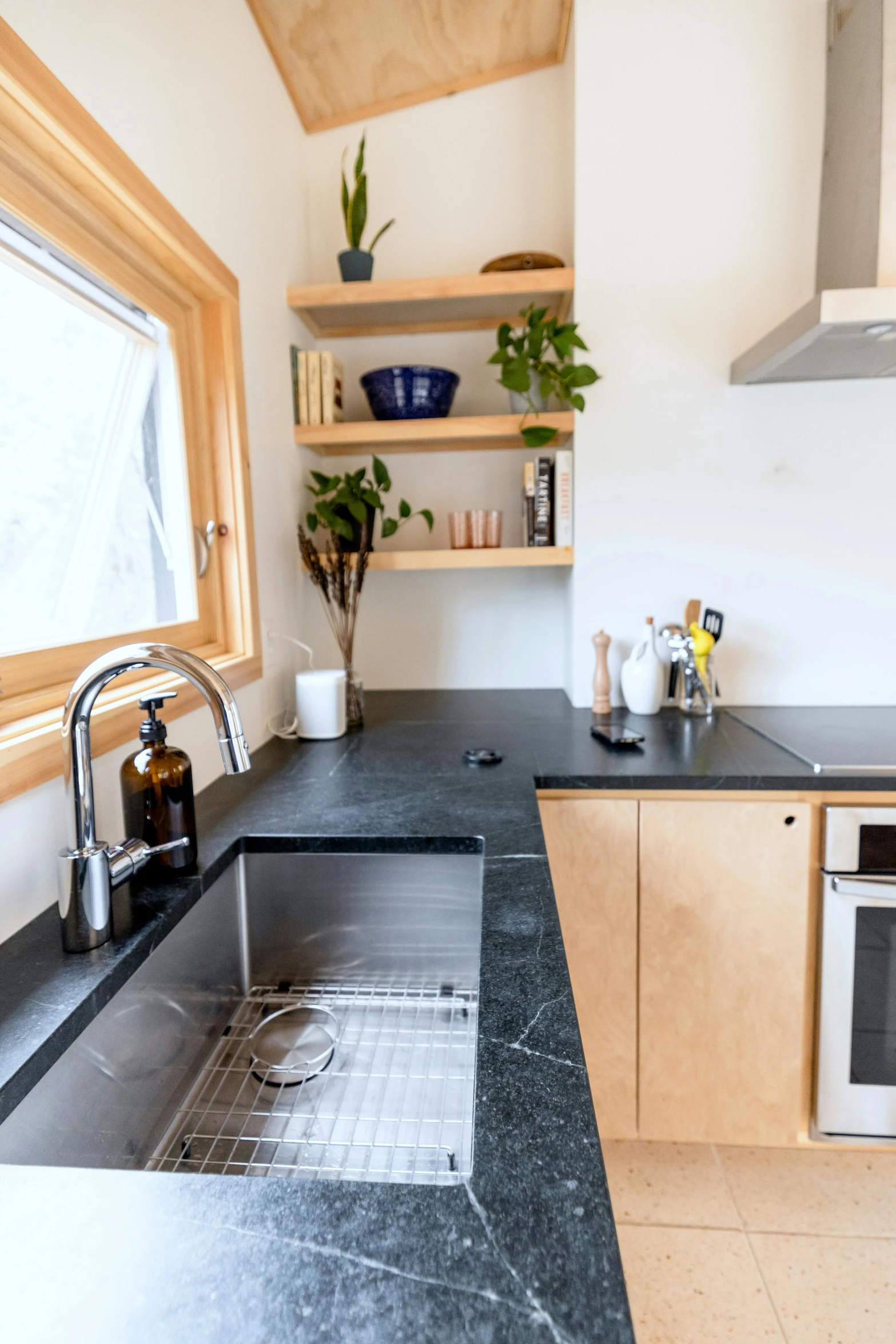 an attractive kitchen has a black marble countertop