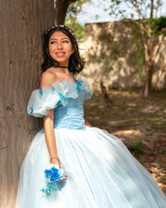 a pretty little girl in her blue and white wedding dress