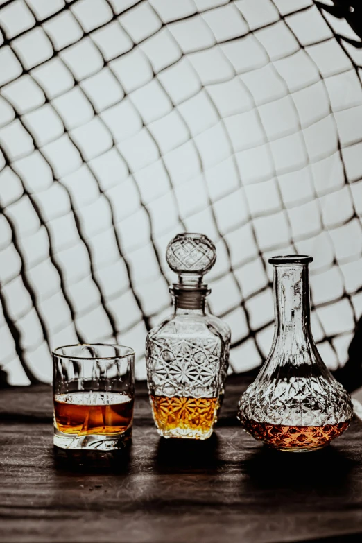 a couple of bottles and glasses on top of a wooden table